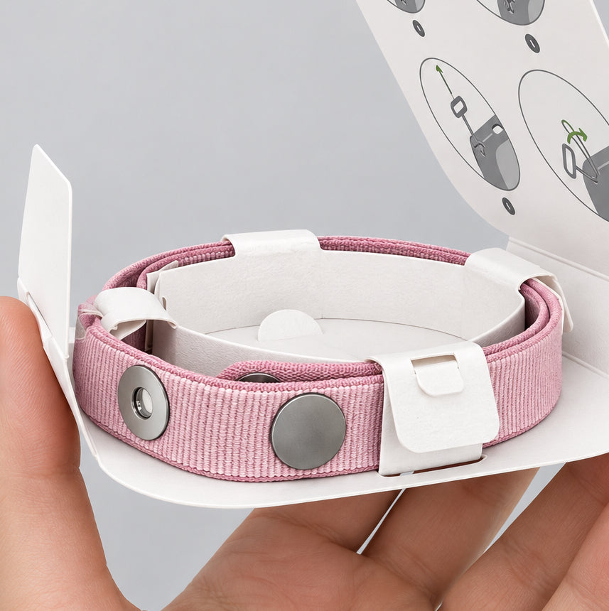 Pink magnetic woven wrist strap in original packaging, held in hand – PhoneHub Lebanon