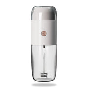LePresso 2-in-1 portable coffee grinder and milk frother in white, showing grinder top and frother handle
